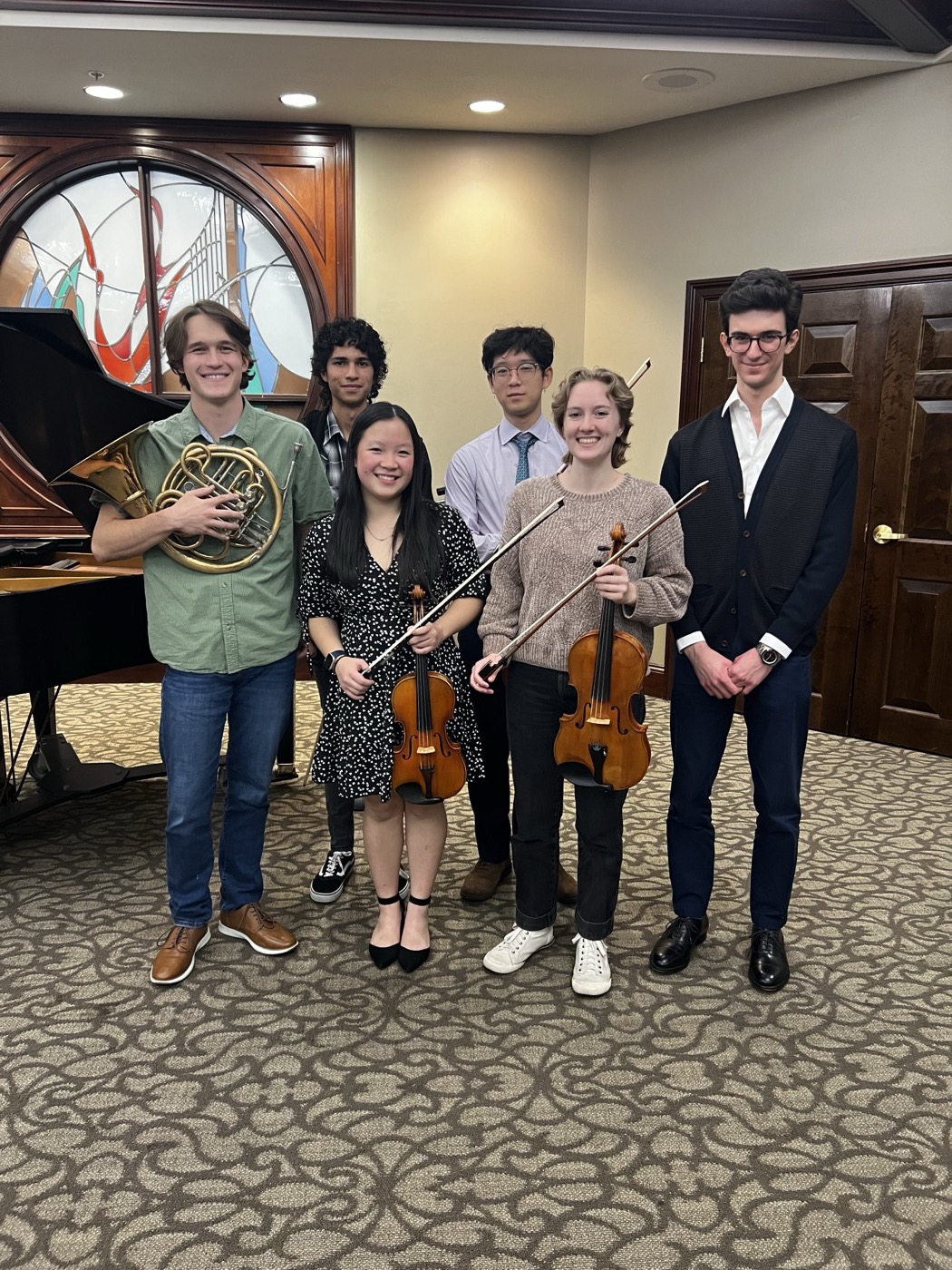 Soli student musicians posing with their instruments before a performance